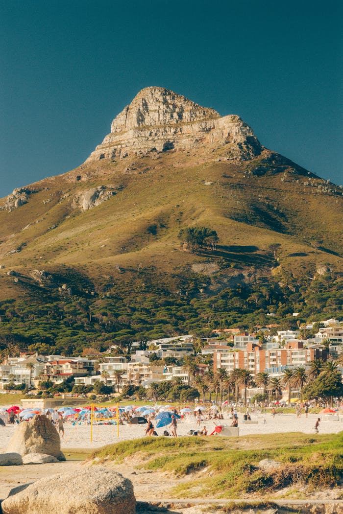 Spectacular view of Lion's Head in Cape Town with beachgoers enjoying the summer sun.